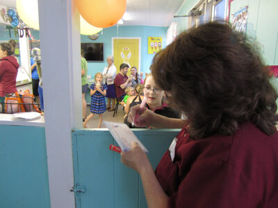 Mary fills out some gift certificate prizes
